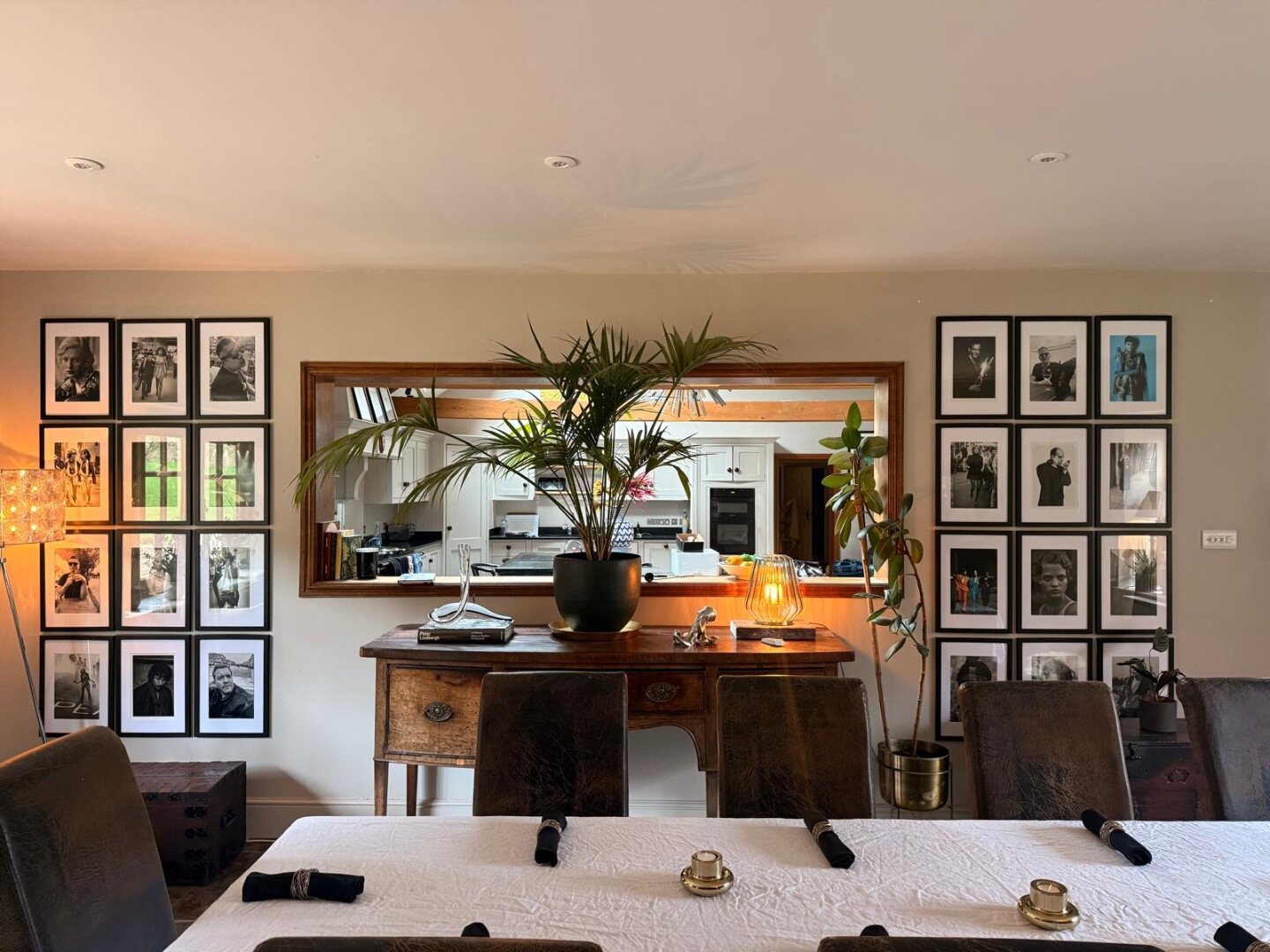 The Bathelona dining room, one long table set for supper, looking through to the kitchen